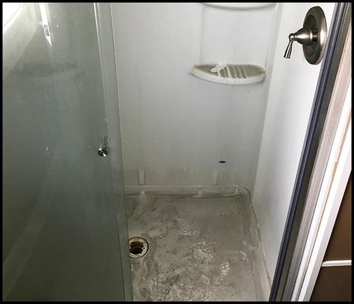 A bathroom shower covered in soot